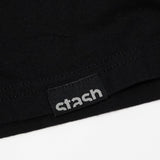 Close up of the Stash logo hem tag on the black Stash Mix t-shirt