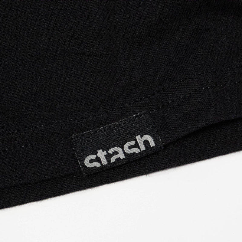 Close up of the Stash logo hem tag on the black Stash Mix t-shirt 